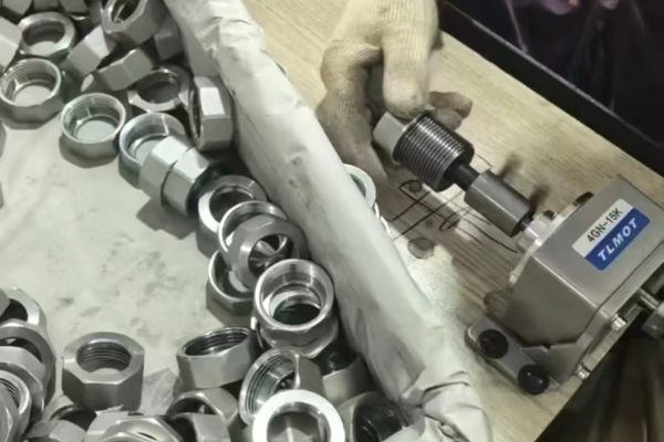 Semi-powered internal thread plug gauge fixture in action on threaded pipe fittings